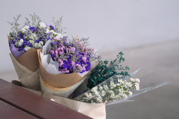 Gypsophila flower panicle near brown wood table