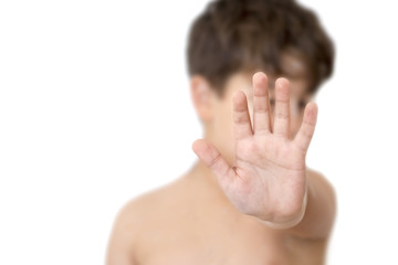 Fototapeta premium Little kid showing stop gesture with palm in front. Isolated on white