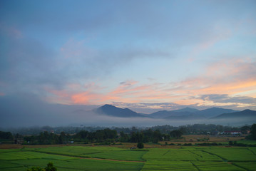 A beautiful tranquil morning sun rise at Rice Field Plantation in Pua village, Nan Province, Thailand