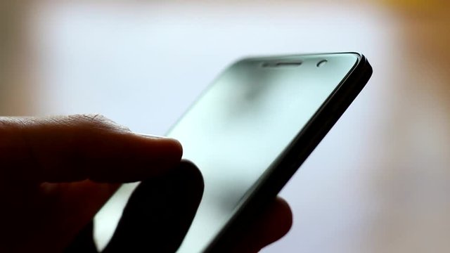 Male Hands Using Smartphone Touchscreen Close-up