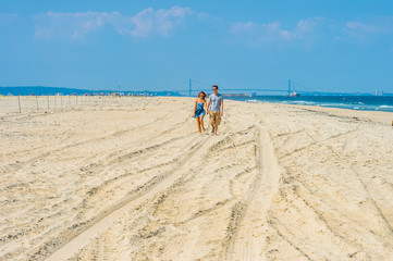 Fototapeta na wymiar Young couple walking, relaxing on the beach in New Jersey, USA