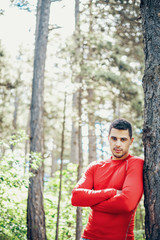 Sporty man posing in forest