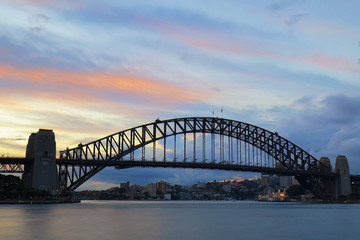 Sydney Harbour Bridge with streaks color of sunset