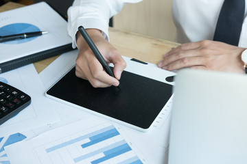 young graphic designer working with computer. creative man using digital tablet and stylus pen at...