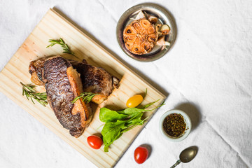 New york strip porterhouse steak meat with vegetables against white background
