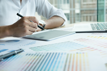 Fototapeta premium graphic designer working with computer , color swatch. creative man using stylus pen and digital tablet at modern office. Architect using sample catalog. 