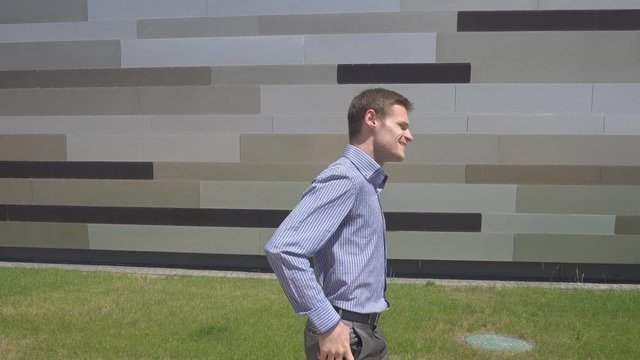 Young motivation Businessman use smart phone while walk outdoor building
