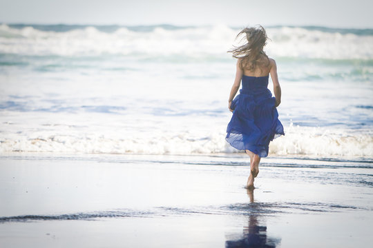 Outdoor Portrait Of Young Beautiful Woman In Blue Gown Posing On Natural Background