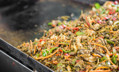Meat and prawns with vegetables for tacos at a street food market