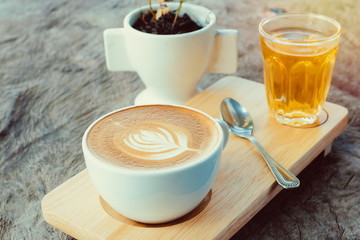 latte art coffee or cappuccino on wooden table background