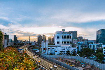 Naklejka na ściany i meble road traffic transportation and city in bangkok at twilight sunray and tree pot
