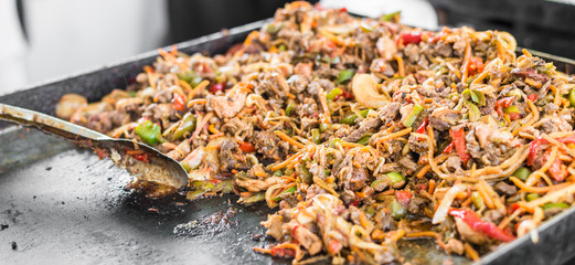 Meat and prawns with vegetables for tacos at a street food market