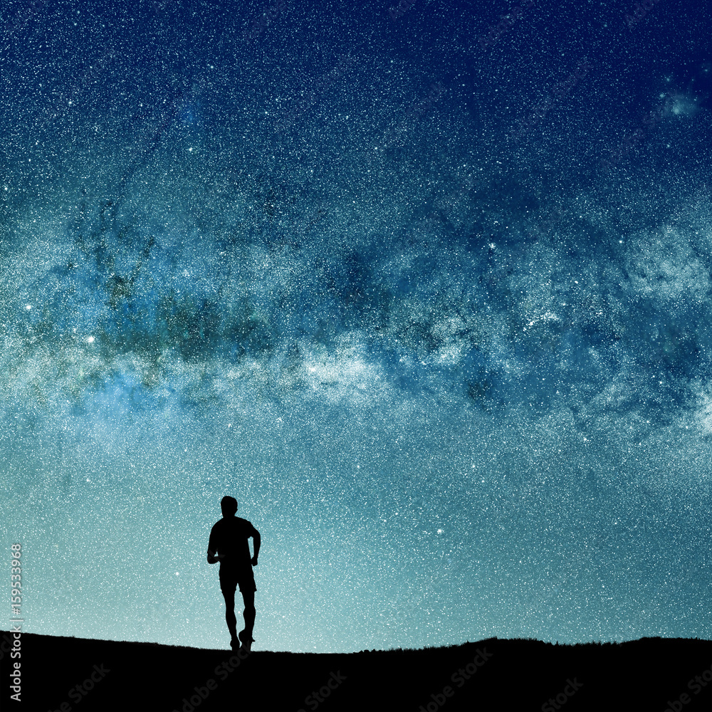 Wall mural conceptual image of silhouetted man and abstract universe lights. nasa galaxy images manipulated and