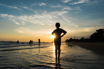 Silhouette of child standing on the beach