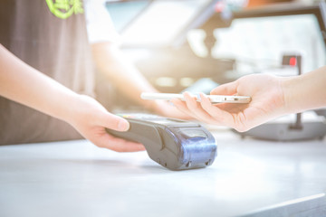 Close up of mobile payment in a shop.