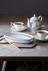 Two cup of tea and teapot on marble table background.