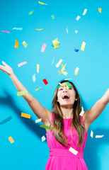Fototapeta premium Happy woman celebrating with confetti