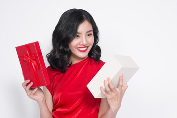 Pretty young glamorous asian woman dressed in red dress with a present