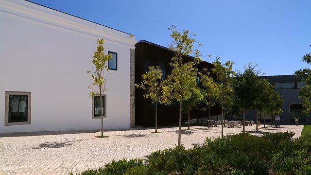 Premises of Cascais Citadel, white buildings and courtyard on sunny day, travel