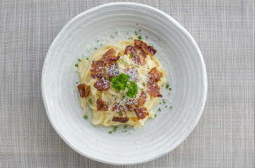 Classic Homemade Pasta Carbonara Italian. Spaghetti with bacon, eggs, parsel and parmesan cheese on white plate