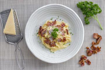 Classic Homemade Pasta Carbonara Italian. Spaghetti with bacon, eggs, parsel and parmesan cheese on white plate