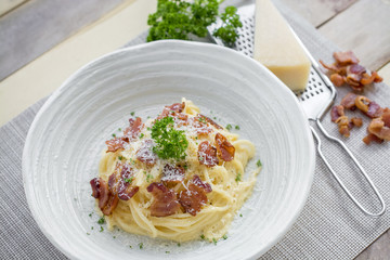 Classic Homemade Pasta Carbonara Italian. Spaghetti with bacon, eggs, parsel and parmesan cheese on white plate