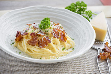 Classic Homemade Pasta Carbonara Italian. Spaghetti with bacon, eggs, parsel and parmesan cheese on white plate