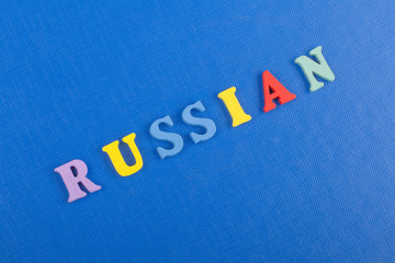 Russia word on blue background composed from colorful abc alphabet block wooden letters, copy space for ad text. Learning english concept.