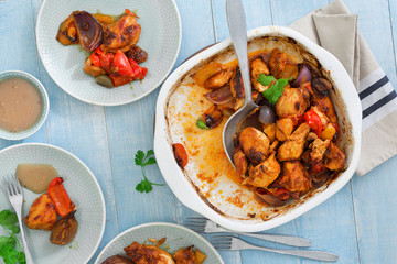 Baked chicken breast with vegetables on blue wooden table