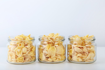 Cornflakes in glass jar isolated on a white