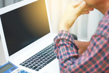 Stock Photo - Blurry businessman using laptop on wooden table in coffee