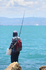 People fishing on the Mediterranean coast
