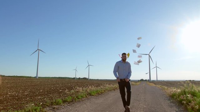 Engineer dances on windmills background.