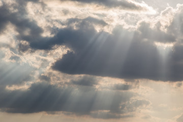 A close view of clouds with sunrays coming out through them