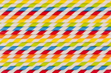 Abstract multicolored rainbow geometric striped background of beverage straw.