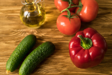 Fototapeta na wymiar Salad ingridients. Tomato, olive, oil, paprika and cucumber.