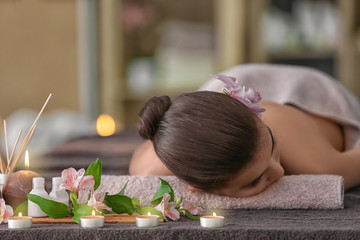 Obraz na płótnie Canvas Beautiful young woman lying on massage table in spa salon