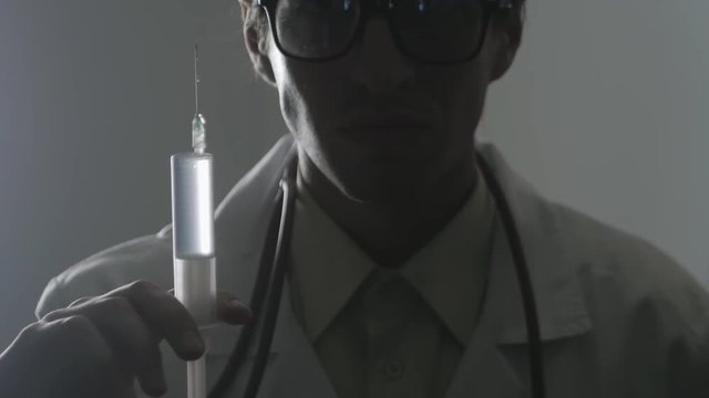 Portrait of a doctor with a syringe. An injection