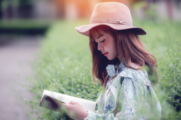 Young woman reading a book  at the park