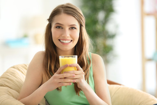 Weight loss concept. Beautiful young woman drinking healthy delicious smoothie at home