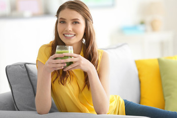 Weight loss concept. Beautiful young woman drinking healthy delicious smoothie at home