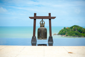The bell located in an infinity edge pool with the sea view