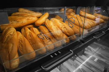 Show-case with delicious fresh bread in bakery