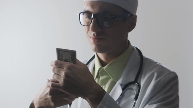 Doctor counts the money. A bribe to a medical worker. Expensive medicine.