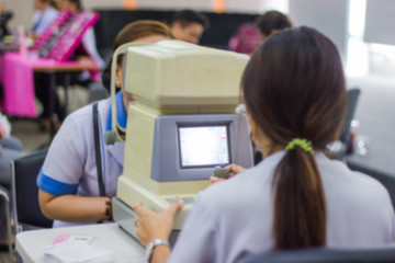 Blur - Ophthalmology clinic - Woman checks the eyes on modern electronic machine