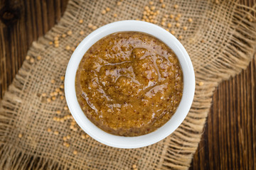 Wooden table with Sweet Mustard (selective focus)