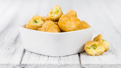 Wooden table with Chili Cheese Nuggets (selective focus)