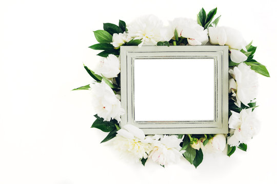 Pastel wooden frame decorated with peonies flowers, space for text. mock up