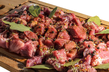 Pieces of appetizing pork with spices on a cutting board