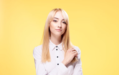 Woman in a white shirt on a yellow background